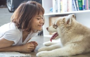 womand smiling with animal